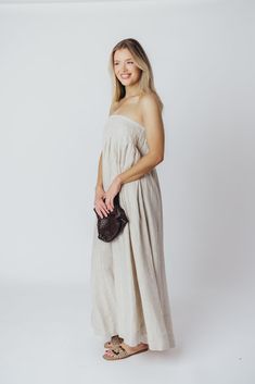 Expertly crafted from premium-quality linen, the Zabina Maxi Dress offers a stylish and comfortable option for all your warm-weather activities. This gem is lightweight, ultra-comfortable, and thanks to its removable straps, a beautifully versatile addition to your wardrobe. FIT: Runs true to size - relaxed fit. MATERIAL: 100% Linen. GARMENT DETAILS: Relaxed maxi dress in 100% linen, with removable spaghetti straps. Features dual in-seam pockets, with a back button closure and gently-defined empire waist. SIZE GUIDE: S (2-4) / M (6-8) / L (10-12) MODEL DETAILS: Heather is wearing size S. Mackenzie - Size S Heather - Size S Molly - Size XL Our Brunette Misses Model Our Blonde Misses Model Our Blonde Curve Model Bust 34" 34" 37" Waist 27.5" 27.5" 32" Hips 40.5" 37.5" 47" Height 5'7" 5'7" 5'7 Linen Dress With Straight Neckline For Vacation, Chic Linen Dress With Straight Neckline, Neutral Linen Dress For Vacation, Natural Linen Vacation Dress, Natural Linen Dresses For Vacation, Neutral Linen Beach Dress, Neutral Linen Dress For Beach, Neutral Linen Dress For The Beach, Beige Linen Dress For Beach