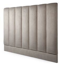 an upholstered headboard made out of grey fabric with vertical pleated panels