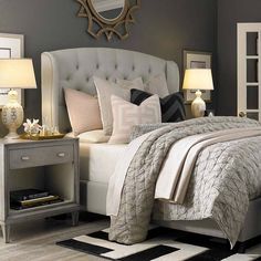 a bedroom with gray walls and white furniture