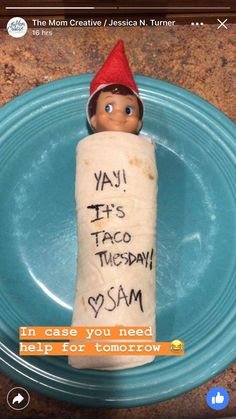 an elf is holding a roll of bread on a plate with the words yah it's taco tuesday