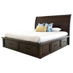 a bed with drawers underneath it and pillows on top of the headboard, in front of a white background