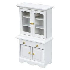 a small white cabinet with two doors and drawers on the bottom, in front of a white background