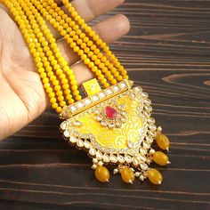 This is a stunning handmade necklace perfect for high end Jewelry Collector, a keeper in Traditional Vintage Indian/Pakistani Bridal jewelry and a Luxury Gift for your Daughter, Sister or Wife on Wedding or Anniversary. Perfect for any type of occasions, weddings And celebrations and a beautiful & memorable gift for weddings and special occasions. -Item Code:- L6059 -Yellow Gemstone Beaded Necklace Set with Earrings. -Designer multi layered faceted Yellow Gemstone beaded necklace. -Gold Plated Set with Kundan Stones which shine like Polki Diamonds. -Metal: Gold plated brass -Earrings are 70mm long & 36mm wide approx -Push Back Earrings -Necklace length with pendant 12" approx excluding adjustable dori/cord -Quantity:- One Necklace Set Please see more different designs here:- https://www.et Luxury Kundan Jewelry In Yellow Gold, Luxury Yellow Gold Kundan Necklace With Meenakari, Luxury Yellow Gold Kundan Necklaces, Yellow Kundan Necklace For Wedding, Traditional Multicolor Gold-plated Kundan Necklace, Multicolor Gold-plated Kundan Necklace Gift, Multicolor Meenakari Gold-plated Necklaces, Necklace Set With Earrings, Pakistani Bridal Jewelry