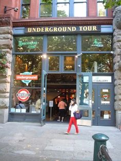 people walking in front of an underground tour store