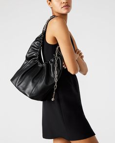 Take on the day with the JASON bag. Featuring a soft hobo-ruched design, a durable chain shoulder strap, and a long chain dangle for added style. The mag snap closure tab keeps your items secure while the spacious yet lightweight design allows for effortless carrying. Go bold with this versatile handbag! Shoulder hobo-ruched bag Chain shoulder strap Mag snap closure Long chain dangle with ball charm Shoulder strap: 13 inches 16.5in H x 9.75in W x .75in D Leather materials Duster bag included Imp Chic Travel Baguette Bag With Chain Strap, Modern Bags With Chain Strap And Double Handle, Chic Shoulder Bag With Chain Strap For Travel, Chic Travel Shoulder Bag With Chain Strap, Modern Double Handle Bag With Chain Strap, Leather Shoulder Bag With Chain Link For Everyday, Leather Chain Link Shoulder Bag For Everyday, Chic Bags With Chain Strap And Double Handle, Modern Shoulder Bag With Chain Strap For Travel