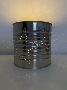 a tin can with some lights on top of it