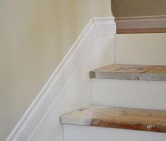 the stairs are made of wood and white paint