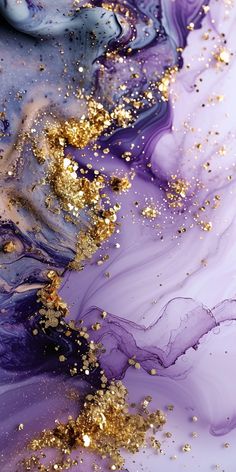 an abstract painting with gold glitters and purple fluid paint on it's surface