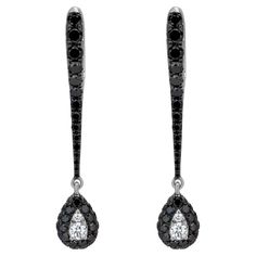 Manifested on an 18K White Gold, Black Rhodium body, this pair of dangling earring looks like an exclamation sign. Uniquely crafted by Luxle, this sleek pair of jewelry has round full-cut white and black diamonds in micro pave and illusion setting. The diamonds are I1 in clarity and GH, Black in color, weighing 1.36 Cts. Dramatic to look at, this pair of earrings is perfect for dressy gown or casual dress. Please follow the Luxury Jewels storefront to view the latest collections & exclusive one Dressy Gowns, Black Diamond Jewelry, Black Diamond Earrings, Diamond Drop Earrings, Black Diamonds, Diamond Drops, Antique Earrings, Black Rhodium, Pearl Drop Earrings