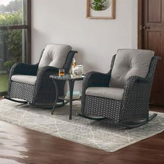 two wicker rocking chairs sitting next to each other on top of a wooden floor