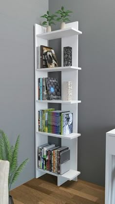 a white book shelf sitting on top of a hard wood floor next to a plant