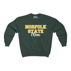 Norfolk State Mom Sweatshirt Officially licensed Norfolk State University collegiate product Sweatshirt: ✔️ Loose fit ✔️ 50% USA Cotton; 50% Polyester ✔️ Runs true to size Discover More Officially licensed Norfolk State University Apparel Celebrating Black excellence. Building legacy. Join the scholar community: @BlackandScholared Proud HBCU-owned business Fall Varsity T-shirt With Logo Print, Crew Neck T-shirt With University Logo For Fall, College Team Name Sweatshirt For Fall, Collegiate Pre-shrunk Sweatshirt For College, Varsity T-shirt For College In Fall, Long Sleeve University Logo Tops For Sports Season, University Logo Long Sleeve Tops For Sports Season, Collegiate Winter T-shirt For Streetwear, Collegiate Letter Print Tops For Fall