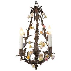 a chandelier with flowers and candles hanging from it's center, against a white background