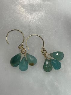 Hand made natural green grandidierite dangle earrings. Turquoise, ocean colors. Made with gold filled ear wires and findings. Measure 1.25" long.  Light catches the stones beautifully, each piece is unique.  Gold filled findings have a 5% real gold layer mechanically bonded to a base metal, and are very durable if taken care of. I include rubber earring stoppers with all earrings. I ship within 3 business days, transit is generally 3-5 business days. Please message me if you need your items by a Dangle Earrings With Amazonite And Natural Stones, Handmade Dangle Amazonite Earrings, Handmade Amazonite Dangle Earrings, Turquoise Apatite Gemstone Earrings, Apatite Dangle Earrings With Natural Stones, Turquoise 14k Gold Filled Earrings For Everyday, Everyday Turquoise 14k Gold Filled Earrings, Turquoise Dangle Earrings With Amazonite, Turquoise Amazonite Dangle Earrings