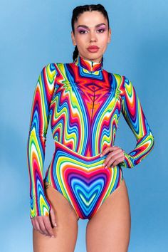 The mesmerizing printed bodysuit, adorned with vibrant zigzagging neon strings representing the full spectrum of colors, transcends the ordinary. With its elegant long sleeves, secure front zipper, and form-fitting silhouette, this bodysuit ensures you stand out in any crowd. Embrace self-love with a resounding voice, my dear, and let your unique essence shine brightly for all to see! It's time to unleash your inner power and make a statement that resonates with the world. > The outfit glows in Rainbow Bodysuit, Rave Bodysuit, Outfit Rave, Bodysuit Designs, Inner Power, Rave Outfit, The Last Picture Show, Festival Clothing, Rave Wear