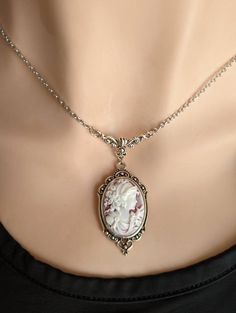 "This beautiful vintage-style Cameo necklace features a classic portrait cameo of a Greek Goddess on a wine coloured background with white relief. Set in an ornate antique silver pendant suspended from a beautiful vintage style floral necklace connector featuring vines and a Tulip. A quintessential gift for anyone that loves vintage-inspired Victorian and Gothic jewelry.  Want to make it an earring and necklace set? You can! Choose your preference in the drop-down menu! NEW! Choose your favourit Cameo Jewelry Necklaces, Old Style Necklace, Antique Necklace Holder, Vintage Looking Jewelry, Vintage Cameo Necklace, Vintage Victorian Jewelry, Vintage Wedding Necklace, Victorian Style Necklace, Victorian Cameo Necklace