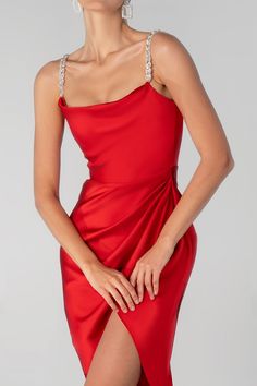 Our ‘Juliet’ midi dress is cut from the softest silk Satin for that perfect drape in a romantic Wine Red hue. It features a glamorous handmade rhinestone crystal Straps. ‘Juliet ' is super comfortable to wear and the bodice features our incredible corsetry boning for a super cinched fit to accentuate your waist and is beautifully draped at the low baring neckline, held by dainty rouleau shoulder straps.The skirt is slightly gathered to really flatter your figure and pleated to delicately drape a Elegant Embellished Draped Dress, Elegant Red Draped Dress, Embellished Draped Party Dress, Glamorous Draped Midi Dress For Cocktail, Elegant Draped Red Evening Dress, Red Satin Embellished Evening Dress, Elegant Red Draped Evening Dress, Red Embellished Satin Evening Dress, Red Embellished Satin Dress