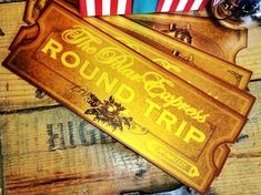 three wooden signs sitting on top of a table