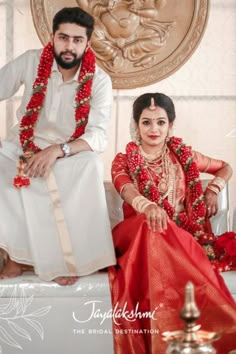 a man and woman sitting on a white couch