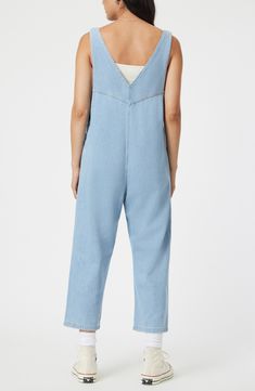 Rock a casual-cool vibe in this lightweight denim jumpsuit designed with front patch pockets and a cropped length. 23 1/2" inseam; 17 1/2" leg opening Side button closure Deep V-neck Sleeveless Front patch pockets 76% cotton, 24% rayon Machine wash, dry flat Made in Turkey Casual Summer Overalls With Side Pockets, Medium Wash Utility Overalls, Utility Medium Wash Overall Jumpsuits, Utility Style Medium Wash Overalls Jumpsuit, Utility Overall Jumpsuits And Rompers In Medium Wash, Casual Light Wash Overalls, Utility Cotton Jumpsuits And Rompers For Summer, Denim Wide Leg Jumpsuits For Summer, Summer Utility Style Straight Leg Jumpsuits And Rompers