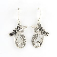 These intricate mermaid dangle earrings are handmade with sterling silver in Bali. Dangle earrings are 1 9/16 inches long and 3/4 inch wide. Earrings come with a pair of clear rubber earring stoppers for the ear wires. Style Number: 16023 Metal: 925 Sterling Silver Dimensions: 1 9/16 inches long and 3/4 inch wide Handmade in Bali, Indonesia Simple Silver Earrings, Silver Mermaid, Ear Wires, Fashion Earrings, Silver Earrings, 4 Inch, Bali, Dangle Earrings, Mermaid