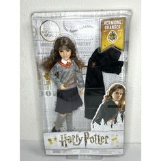 the doll is in its packaging with harry potter clothes