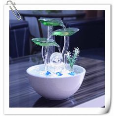 a bowl filled with water and ice on top of a table