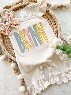 This sweet personalized baby sleeper is soft and comfortable to snuggle a little one. This custom outfit makes a perfect coming home outfit, newborn pictures, or baby shower gift. This features a soft oatmeal flutter sleeve romper, the baby's name in pink, yellows, and blue across the front. You can get a handmade bow to finish off this cute outfit! Newborn fits approximately 6-8lbs 0/3 fits approximately 9-13lbs Please leave name in the notes to seller box at checkout.  All embroidered items ha Coming Home Outfit Baby Girl, Baby Sleeper, Outfit Baby Shower, Newborn Coming Home Outfit, Embroidered Items, Custom Baby Gifts, Baby Shower Outfit, Baby Sleepers, Baby Fits