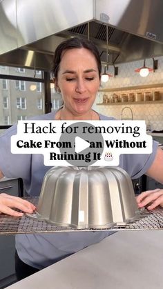 a woman holding a cake pan with the words hack for removing cake from an without running it