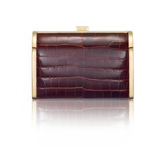 A new silhouette from STALVEY's signature collection, the Rounded Clutch is an evening clutch with alligator or lizard skin, perfectly placed within a palladium or 24kt gold hardware frame. A rounded curvature at the top front of the clutch provides an elegant feel. Square push pin opens the clutch up to a spacious leather-lined interior. Two custom STALVEY twist screws on either side of the chain provides an adjustable shoulder strap drop height, perfect for transitioning from daytime wear to e Elegant Evening Clutch With Crocodile Pattern, Formal Compact Leather Clutch, Elegant Formal Clutch With Crocodile Pattern, Luxury Rectangular Clutch, Elegant Rectangular Clutch With Palladium Hardware, Elegant Rectangular Clutch With Crocodile Pattern, Formal Rectangular Clutch With Palladium Hardware, Elegant Rectangular Crocodile Pattern Clutch, Classic Formal Clutch With Palladium Hardware