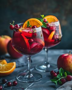 two glasses filled with red wine and fruit