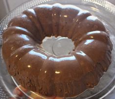 a chocolate bunt cake sitting on top of a glass plate