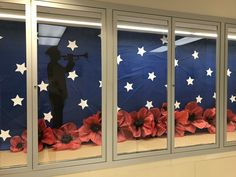 the window is decorated with red, white and blue paper flowers