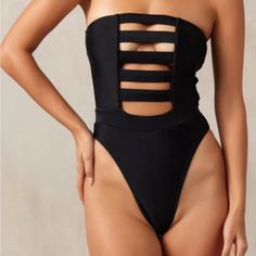 This One-Piece Is The Perfect Combination Of Classy And Sexy. Boning And Silicone Elastic Keep This Strapless One-Piece Up And In Place So You Feel Comfortable And Secure. Ultra Soft Material, Strapless, Double Lined Brazilian Bottom Coverage High Cut At Hips Elongate The Legs Elastic In Waistband Cinches In Waist Sleeveless Cutout Swimwear For Club, Bandeau Beachwear Swimwear For Club, Beachwear Bandeau Swimwear For Club, Club Beachwear Bandeau Swimwear, Black Bandeau Swimwear For Night Out, Strapless Stretch Swimwear For Club, Strapless Black Bodysuit For Club, Black Strapless Bodysuit For Club, Strapless Lined Bodysuit For The Beach