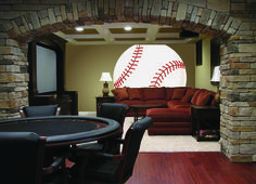 a living room filled with furniture and a baseball wall decal in the middle of it