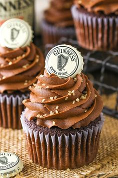 two cupcakes with chocolate frosting and a bottle of wine