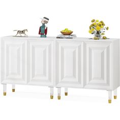 a white cabinet with yellow flowers and a figurine on top