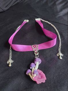 Very pretty little purple swirly mushroom cluster set on a pink quartz geode.  Pendant is set on a filigree piece, adorned with swarovski crystals. Sits on a 13 inch ribbon choker that has extenders on both sides so its able to fit  from 13 to 19 inches, if you need it longer let me know and I can move the clasp. Adjustable Whimsical Choker, Handmade Whimsical Choker Jewelry, Whimsical Adjustable Choker, Whimsical Party Choker Jewelry, Adjustable Pink Jewelry For Festivals, Purple Whimsical Necklace For Party, Adjustable Whimsical Jewelry For Party, Whimsical Purple Necklace For Party, Whimsical Pendant Jewelry For Party