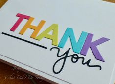 a thank card with the word thank you written in multicolored letters on it