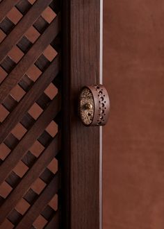 a close up of a wooden door with a ring on it