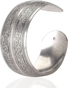 PRICES MAY VARY. Tibetan Silver Material: Crafted from Tibetan silver, this bracelet exudes a unique and elegant charm that is perfect for any woman's wardrobe. Carved Spiral Flower Design: The intricate carvings of spiral flowers and connecting branches create a visually stunning pattern that is both eye-catching and charming. Wide Band Style: The wide band design of this bracelet not only adds a bold and stylish touch to your ensemble, but also ensures a comfortable fit. Open Cuff Style: The o Silver Bangle Bracelets Cuffs, Spiral Flower, Womens Cuff Bracelets, Open Cuff Bracelet, Silver Bangle Bracelets, Elastic Bracelet, Bracelet Bangle, Wide Bands, Adjustable Bracelet