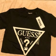 Guess Crop T-Shirt Black Guess Logo Nice New Size Xsmall Bundle Your Items To Save On Shipping! Box-A4 Fitted Logo Top With Short Sleeves, Fitted Short Sleeve Tops With Logo, Logo Fitted Crew Neck Top, Black Fitted Tops With Logo, Trendy Black T-shirt With Logo, Trendy Black Tops With Logo, Casual Short Sleeve Logo Top, Black Logo Top With Short Sleeves, Black Short Sleeve Tops With Logo