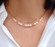 This double strand necklace is delicately made with high quality natural freshwater pearls. Ideal for bringing an elegant and chic style to all your outfits, it is perfect for a gift (wedding, birthday) for someone or for yourself (-: - Details - . Materials: - Gold stainless steel chain - Natural freshwater pearl 4×5mm . Necklace length 1st row satellite chain: 38cm 2nd row chain: 39cm +5cm adjustable chain. . The chain and the lobster clasp allow the necklace to be perfectly adjusted to the size of the neck (possibility of modifying the length of the necklace on request) . The necklace is sent (by registered letter) with an organza bag. If you mark the order as a gift, I will put the necklace in a gift bag closed with a sticker before posting it. . The stones used are natural, therefore White Layered Pearl Chain Necklace As Gift, White Pearl Chain Layered Necklace As Gift, Double Strand Pearl Layered Necklace Gift, Double Strand Pearl Layered Necklace As Gift, Double Strand Pearl Layered Necklace For Gift, Elegant Double Strand Pearl Necklace For Layering, Dainty White Double Strand Pearl Necklace, Elegant Double Strand Layered Necklace With Pearl Charm, White Double Strand Pearl Layered Necklace