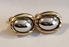 "Elegant Oval Earrings in Gold/Silver Tone.  Signed \"Napier\"  and Patent 3.176.475. Pre-loved condition. Measures 1\"X 0.7\"." Silver Clip-on Earrings With Polished Finish For Anniversary, Silver Oval Clip-on Earrings For Formal Events, Silver Oval Clip-on Earrings For Formal Occasions, Silver Polished Clip-on Earrings For Anniversary, Silver Hallmarked Clip-on Earrings For Formal Occasions, Formal Silver Clip-on Plug Earrings, Silver Oval Clip-on Earrings, Silver Clip-on Plug Earrings For Formal Occasions, Silver Round Clip-on Plug Earrings