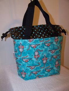 Offering a drawstring insulated Lunch Bag.  Sweet mouse design combined with black poly strap handles and brown polka dot batik drawstring top. Such a fun style design that is sure to please you. The lining is BPA free, food safe rip stop nylon in clean bright white. The rip stop nylon lining is moisture resistant and will hold spills for a limited time.The  cotton drawstring top pulls closed with black paracord and holds tight with easy open cord locks in black. Handles are sewn with triple sti Cute Blue Lunch Bag For Gift, Drawstring Lunch Bag, Cat Footprint, Cooler Food, Lunch Cooler, Brown Polka Dots, Black Handles, Turquoise Background, Insulated Lunch Box