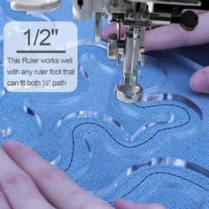 someone using a sewing machine to sew something on the blue fabric that is being stitched