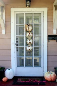 the front door is decorated with pumpkins and decorations