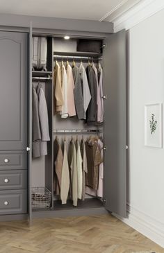 an open closet with clothes hanging on hooks