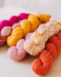 several skeins of yarn sitting on top of a table