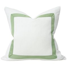 a white and green pillow with a square border on the front, sitting against a white background